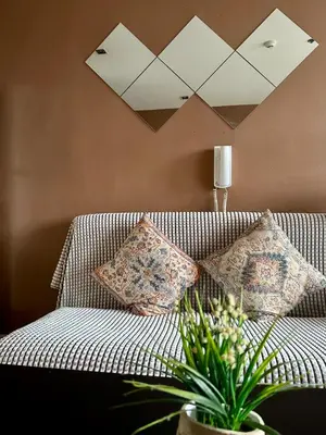 a couch with pillows on it in a living room at High Sunset View with Fast WiFi, Pool, Big Balcony, Gym Access in Manila