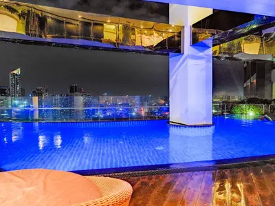 a swimming pool on top of a building with a city skyline at High Sunset View with Fast WiFi, Pool, Big Balcony, Gym Access in Manila