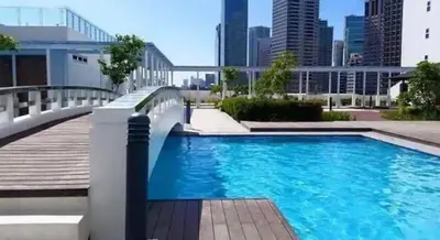 a swimming pool with a city skyline in the background at Charming 2 Bedroom Makati Condo in Manila