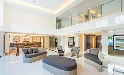 a large living room with two couches and chairs at Charming 2 Bedroom Makati Condo in Manila