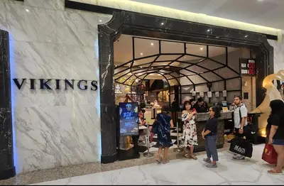 a group of people standing outside of a vikings store at Charming 2 Bedroom Makati Condo in Manila