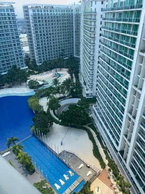 an aerial view of a resort with a pool and buildings at Condotel Azure Beachview in Manila