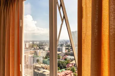 a view of a city from a window at Twin Bed Hotel Type by Ph Philstay in Manila