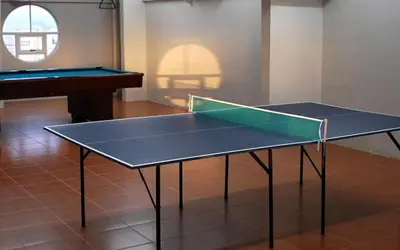 a ping pong table in a room with a piano at Twin Bed Hotel Type by Ph Philstay in Manila