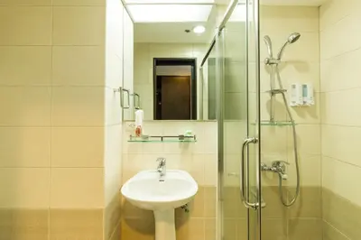a bathroom with a sink and a glass shower at Twin Bed Hotel Type by Ph Philstay in Manila