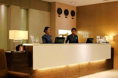 two women sitting at a counter with their laptops at Twin Bed Hotel Type by Ph Philstay in Manila