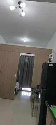 a kitchen with a black refrigerator and a window at Shore 2 Staycation nice Homes in Manila