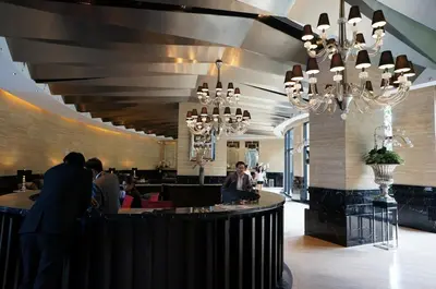 a restaurant with people sitting at a bar at New York- Inspired Condo in Makati in Manila