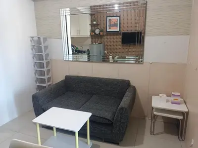 a small living room with a couch and a table at Theresa Sea Residence Tower EF in Manila