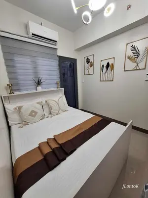 a bedroom with a large bed in a room at 2BR Apartment plus FREE parking Near NAIA in Manila