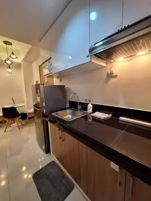 a kitchen with a sink and a counter top at 2BR Apartment plus FREE parking Near NAIA in Manila