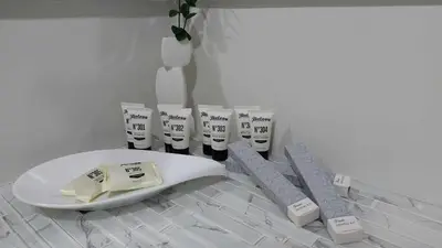 a white toilet with a bunch of toothbrushes on it at 2BR Apartment plus FREE parking Near NAIA in Manila