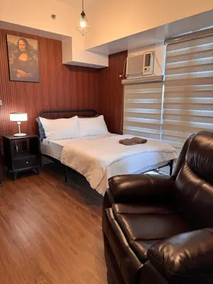a small room with a bed and a couch at Condo in Mckinley Hill Taguig in Manila