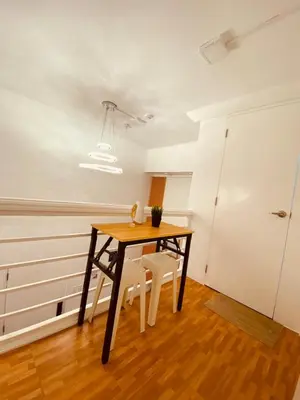 a dining room with a table and two chairs at Cozy SpaciousLoft near MRT BONI in Manila