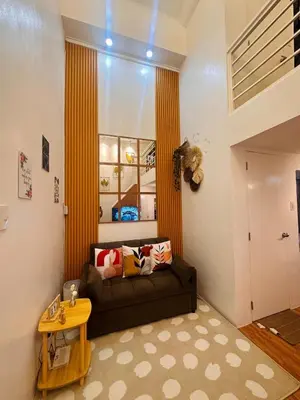 a living room with a couch and a table at Cozy SpaciousLoft near MRT BONI in Manila