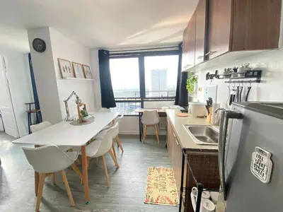 a kitchen with a table and chairs and a counter top at 2 BR Unit with 180 degree view in Ortigas in Manila