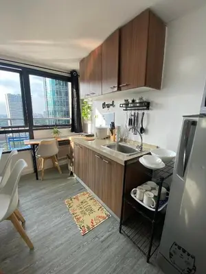 a kitchen with a sink and a counter top at 2 BR Unit with 180 degree view in Ortigas in Manila