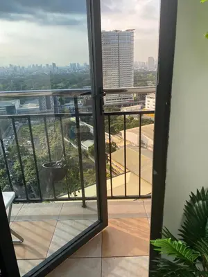 an open door to a balcony with a view of a city at 2 BR Unit with 180 degree view in Ortigas in Manila