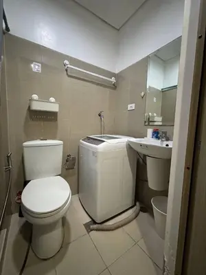 a bathroom with a toilet and a sink at Condo in Pasay in Manila