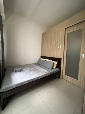 a large bed in a room with a mirror at Condo in Pasay in Manila
