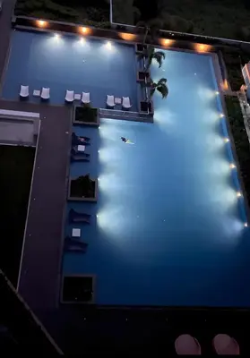 an overhead view of a pool with chairs and lights at 175 Sqm Luxurious Modern 3 Bedrooms Facing Manila Bay Sunset, Airports, Okada, Solaire, MOA in Manila