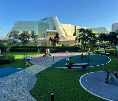 a park with a playground with people sitting on benches at 175 Sqm Luxurious Modern 3 Bedrooms Facing Manila Bay Sunset, Airports, Okada, Solaire, MOA in Manila