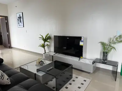 a living room with a couch and a tv at 175 Sqm Luxurious Modern 3 Bedrooms Facing Manila Bay Sunset, Airports, Okada, Solaire, MOA in Manila