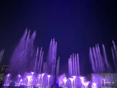 a water fountain is lit up in the dark at 175 Sqm Luxurious Modern 3 Bedrooms Facing Manila Bay Sunset, Airports, Okada, Solaire, MOA in Manila