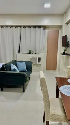a living room with a couch and a table at Newport City across NAIA Terminal 3 by II JDs Aparthotel in Manila