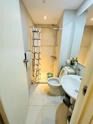 a bathroom with a toilet and a sink at Miami 1909 in Manila