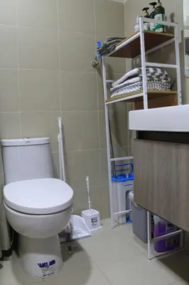 a bathroom with a toilet and a sink at Cozy Urban Nest in Manila