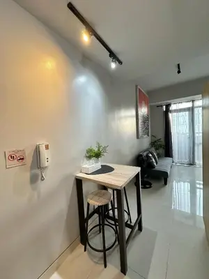 a room with a table and a chair in it at Studio in Araneta City Fast Wifi Great Location in QC in Manila