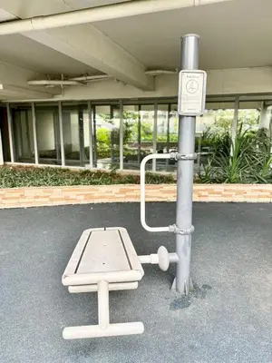 a pole with a bench in front of a building at Studio in Araneta City Fast Wifi Great Location in QC in Manila