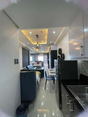 a kitchen and living room with a couch and a table at 1553 Moa view bigcut in Manila