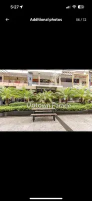a picture of a bench in front of a building at BGC Taguig Uptown 3BR corner unit with pool view, bath tub, wifi, parking, beside Landers BGC in Manila