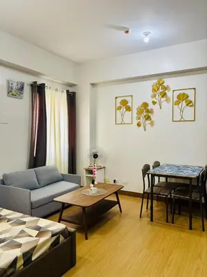 a living room with a couch and a table at Balauro's Haven in Trece Martires