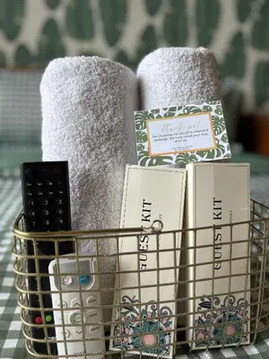 a basket filled with towels and books on a table at Affordable Cozy Plage by Martian in Manila