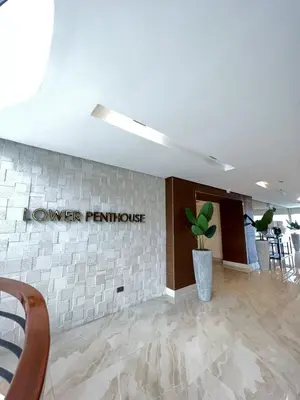 a lobby with a sign that reads lower furniture at 2BR Solana Suite 4 at Coast Residences in Manila