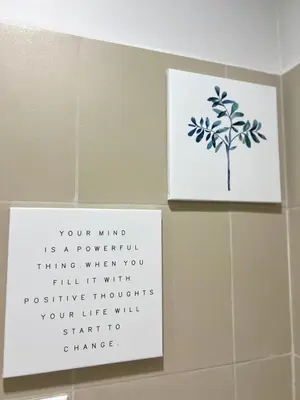 a bathroom with two signs on the wall at 1BR Solana Suite 5 at Coast Residences in Manila