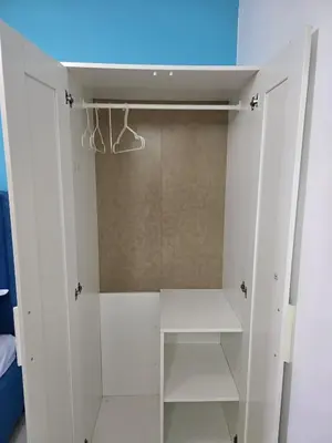 a closet with white cabinets and a blue ceiling at 1BR Solana Suite 5 at Coast Residences in Manila