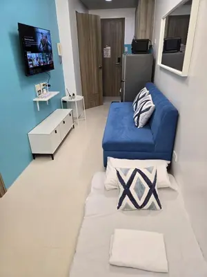 a hospital room with two beds and a tv at 1BR Solana Suite 5 at Coast Residences in Manila