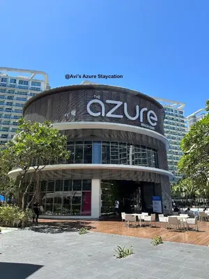 a large building with a sign on top of it at Azure Urban Resort Residences in Manila