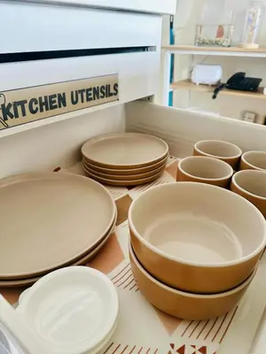 a group of plates and bowls sitting on a shelf at Azure Urban Resort Residences in Manila