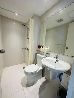 a bathroom with a white toilet and a sink at Azure Urban Resort Residences in Manila