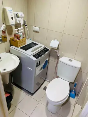 a small bathroom with a toilet and a sink at 333D- 1br 1folding bed pool view in Manila