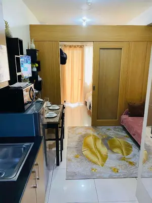 a kitchen with a living room with a table and a room with a kitchen at 333D- 1br 1folding bed pool view in Manila