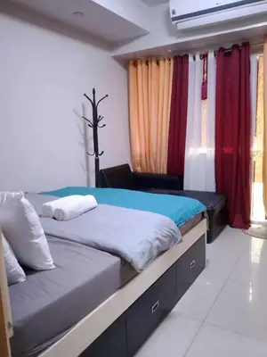a bedroom with two beds and a window at 257 moa view with balcony bigcut in Manila