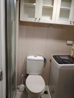 a small bathroom with a toilet and a sink at 257 moa view with balcony bigcut in Manila