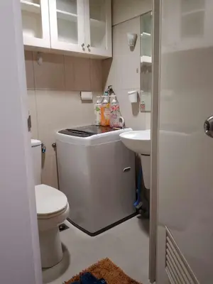 a small bathroom with a toilet and a sink at 257 moa view with balcony bigcut in Manila
