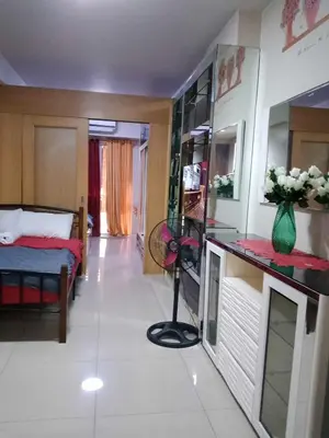 a small room with a bed and a room with a room at 257 moa view with balcony bigcut in Manila